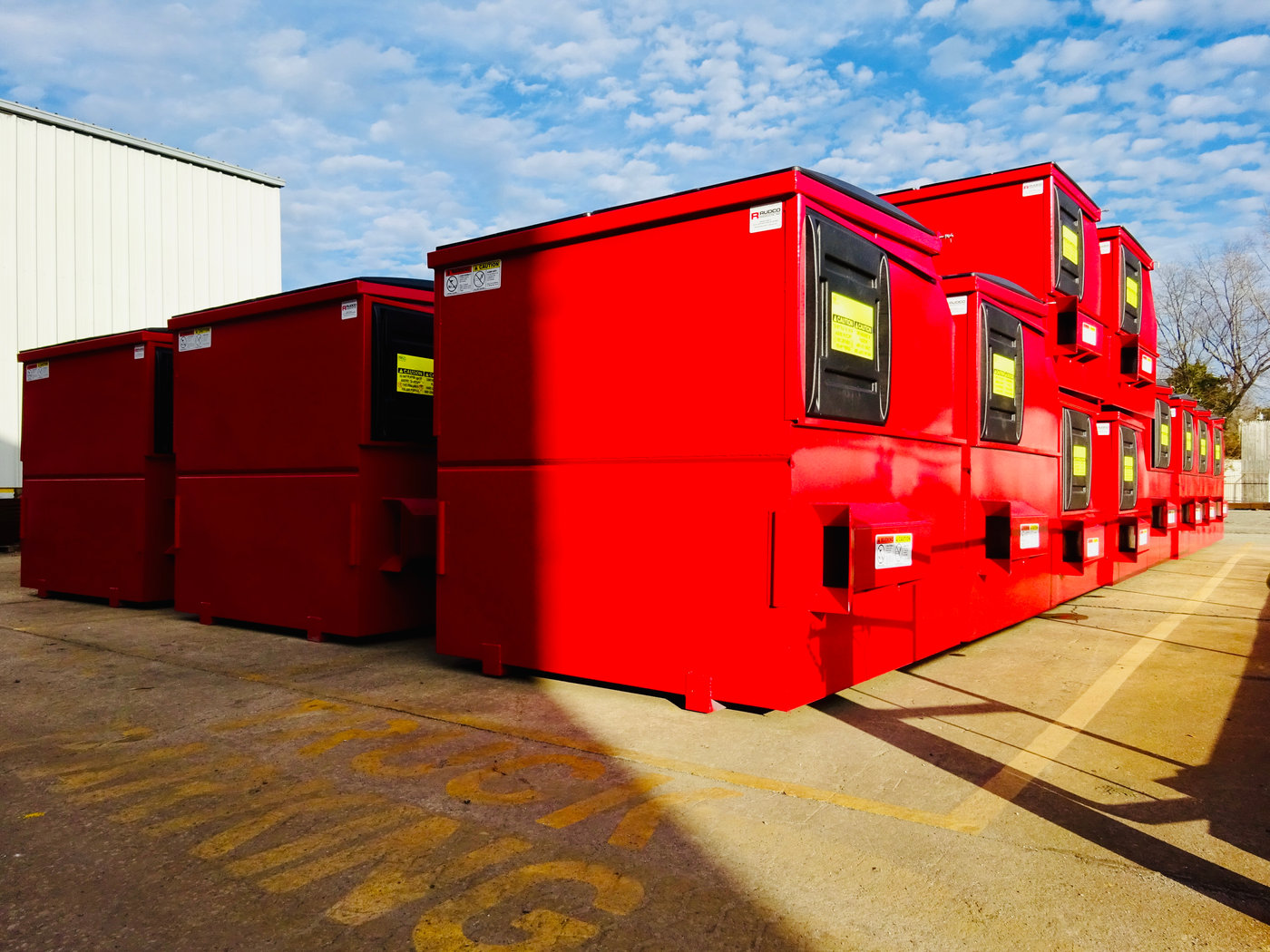Stacked 6 and 8 yard front-load containers in red
