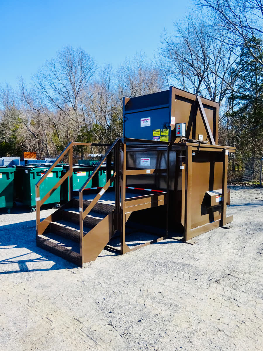 Brown vertical trash compactor with steel steps